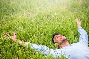 man lying in grass outdoor living fresh perspective landscapes blue mountains