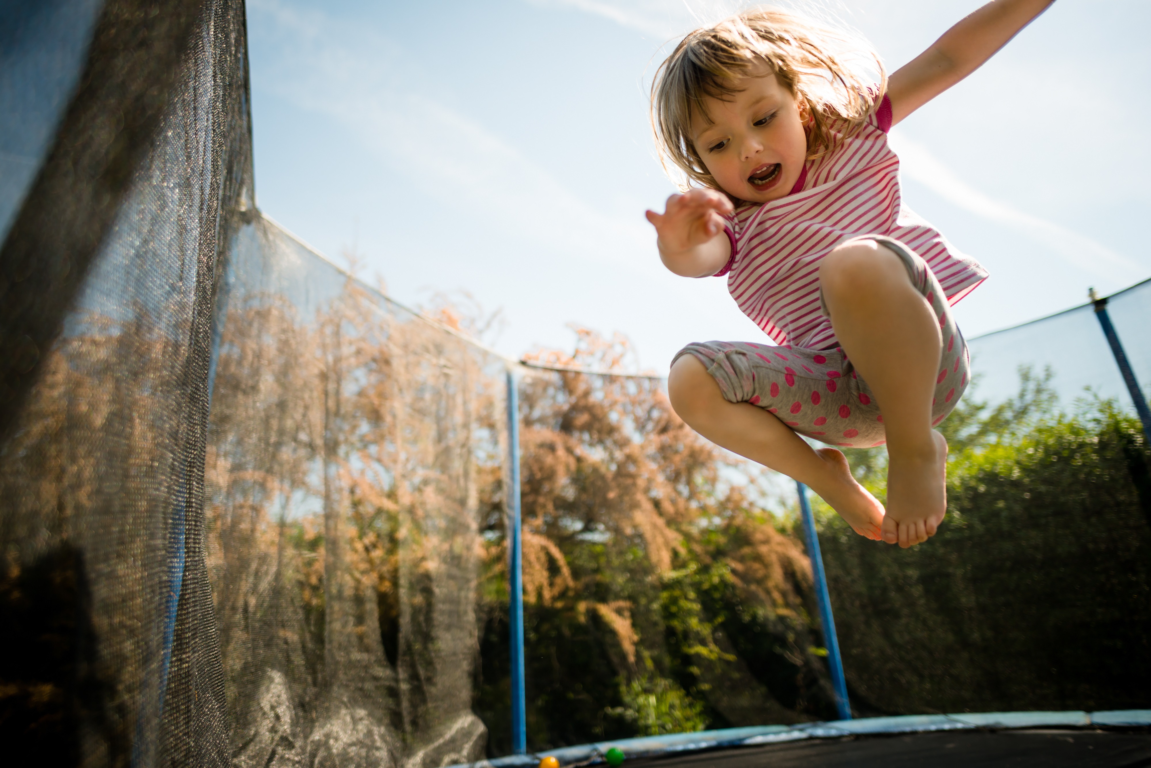 little girl jumping on trampoline fresh perspective landscapes get outside ...