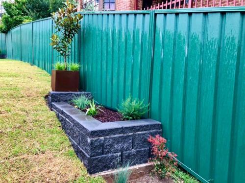 block retaining wall construction surrounding garden bed